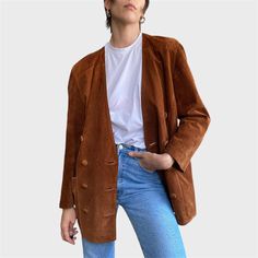 Get 90s nostalgia with this vintage tan brown suede leather jacket, featuring a stylish button closure. Made from high-quality leather, this size M jacket is not only trendy this season but also timeless in its design. Perfect for layering and adding a chic, retro vibe to any outfit, it's a must-have piece for fashion lovers looking to elevate their wardrobe. CONDITION: Great Vintage Condition FABRIC: genuine suede leather SIZE: UK 10/M, EU 38/M , will fit other sizes depending on desired fittin Brown Suede Leather Jacket For Work, Brown Suede Blazer For Work, Casual Brown Double-breasted Blazer, Brown Leather Button-up Blazer, Brown Suede Leather Jacket With Buttons, Brown Suede Single Breasted Blazer, Suede Blazer With Button Closure, Brown Leather Jacket With Button Closure For Fall, Vintage Double-breasted Leather Jacket For Fall