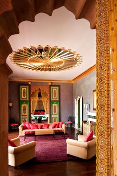 a living room filled with furniture and a chandelier