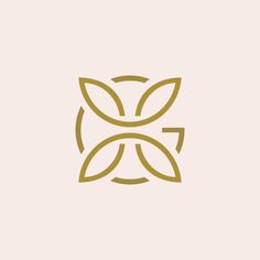 the logo for an artisan shop with leaves in gold on a white background,