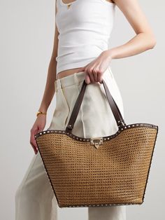 VALENTINO GARAVANI Rockstud leather-trimmed raffia tote | NET-A-PORTER Vacation Outfit Ideas, Valentino Garavani Bag, Ipad Planner, Vacation Outfit, Raffia Bag, Valentino Rockstud, Crochet Bags, Pump Sandals, Open Top