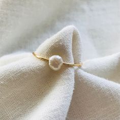 This handmade pearl ring is the perfect accessory for wveryday wear, stacking with other rings, or adding a little something to a formal outfit. Minimalist Pearl Drop Ring For Gift, Minimalist Adjustable Pearl Ring With Charm, Minimalist Pearl Drop Ring For Everyday, Minimalist Pearl Drop Ring, Minimalist Everyday Pearl Drop Ring, White Pearl Ring With Pearl Charm In Minimalist Style, Minimalist Everyday Pearl Ring With Charm, Everyday Minimalist Pearl Drop Ring, Dainty Pearl Ring With Pearl Charm For Gifts