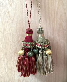 two tasseled ornaments hanging on a wall