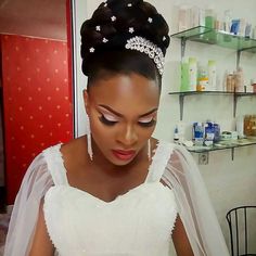 a woman in a wedding dress looking down at her phone