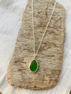 "This beautiful vibrant Green Sea Glass necklace is set in sterling silver bezel and comes on an 18\" sterling silver trace chain. I don't have a backing on my sea glass pieces as this lets the light shine through the sea glass and show off its colour, there is just 3mm bezel around the edges. This one is such a lush green which is harder to find! I found this gorgeous piece in Seaham on a sea glass hunting trip. Gift wrapping is complimentary. Sea glass is glass that has made its way into the O Handmade Green Sea Glass Necklace, Seaglass Necklace, Sea Glass Pendant, Hunting Trip, Necklace Green, Sea Glass Necklace, Glass Pieces, Green Sea, Vibrant Green