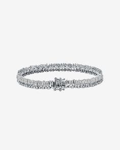 Discover the elegance of our Short Stack Diamond Tennis Bracelet, showcasing a stunning arrangement of 5.65 carats of vertically aligned baguette-cut white diamonds. This exquisite piece is complemented by a row of sparkling round white diamonds, all set against the luxurious backdrop of 18K gold. This bracelet blends classic charm with contemporary flair. Details 18k white gold or yellow gold 5.65 carats of baguette and round white diamonds Bracelet measures 7 inches in length Box clasp with sa Short Stack, Diamonds Bracelet, Diamond Stacks, Fresh Perspective, Diamond Tennis Bracelet, Baguette Diamonds, Vs Diamond, Box Clasp, Jewelry Tray