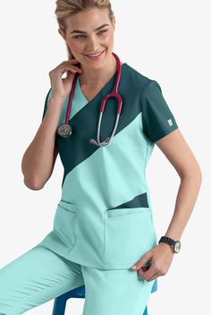 Do you crave fashion in your scrub top collection? Each top showcases two contrasting colors in an asymmetric pattern for a modern look. Each piece in our Butter-soft Stretch scrub collection was designed for 12+ hour shifts, and made from easy-care, 2-way stretch comfort fabric. • Classic fit • V-neck • Total of 5 pockets • 2 double pockets • 1 cell phone pocket • Short sleeve • Side vents • Back darts • Approximate length for size M is 27 1 2” The key to comfort? Cotton and 2-way stretch. They Stylish Scrubs For Women, Male Scrubs, Nursing Scrubs Pattern, Scrub Collection, Scrubs Pattern, Stylish Scrubs, 12 Hour Shifts