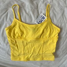 Bright Yellow Crop Top With Straps And Corset Hem Details. The Brand Is Ambiance And Has Tags. Never Worn. Yellow Sleeveless Crop Top With Built-in Bra, Yellow Crop Top With Built-in Bra, Yellow Tank Top With Built-in Bra For Spring, Yellow Tank Top With Built-in Bra For Summer, Yellow Summer Top With Built-in Bra, Yellow Stretch Top With Built-in Bra, Yellow Camisole Crop Top For Summer, Summer Yellow Crop Top With Built-in Bra, Yellow Crop Top With Built-in Bra For Spring