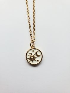 This beautiful sun and moon necklace a perfect treat for yourself or a gift for someone special. The gold plated celestial pendant is approximately .5" wide and .5" tall.  Perfect for layering necklaces or to wear as one necklace. Golden 304 Stainless Steel Satellite Cable Chain with Lobster Claw Clasp Rack plated brass enamel, long-Lasting Plated, Lead Free & Cadmium Free, Real 18K Gold Plated Colors may vary based on screen settings, lighting, etc.  Returns not accepted but please email me with any problems. Items sold in my shop are meant for adults only. Keep away from children. We are not responsible for allergic reactions. Stone, Gemstone Mineral necklaces are not promised to bring specific effects. Everyday Celestial Moon Charm Necklace, Everyday Celestial Moon Necklace, Celestial Sun And Moon Necklace, Celestial Pendant Necklaces For Everyday, Everyday Celestial Pendant Charm Necklaces, Sun And Moon Design Necklace As Gift, Sun And Moon Design Necklace For Gift, Gift Moon And Sun Design Necklaces, Dainty Sun And Moon Design Charm Necklace As Gift