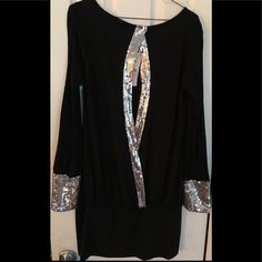 Check Out This Black Party Dress That Has A Splash Of Sequence Embedded Down The Middle And On The Sleeves Which Gives This Dress That Pop To Make People Go Aw. This Dress Can Be Worn To That Right Party Or Club On A Night Out With The Girls. Silver Sequin Long Sleeve Dress For Night Out, Silver Long Sleeve Sequin Dress For Night Out, Elegant Silver Sequin Dress For Party, Chic Silver Sequin Holiday Dress, Elegant Silver Sequin Party Dress, Black Disco Party Dresses, Metallic Long Sleeve Mini Dress For Party, Silver Sequin Dress For Night Out, Silver Sequin Evening Dress For Party