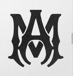 the letter m is made up of black and white paper with an intricate design on it