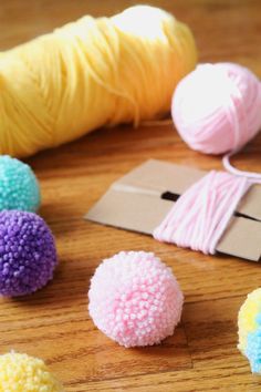 several balls of yarn and two skeins of cotton on a table next to each other