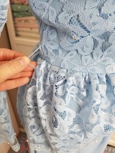 "Pretty dress in an icy periwinkle shade of blue. The top has a layer of lace in a peplum style that is longer in the back. The lace is adorned with tiny pearls and prong set rhinestones. This dress has long sleeves and zips up the back. Hook and eye at top of zipper. Has belt loops and no belt. Has some 40's vibes! Label reads, \"The Bridal Shoppe of Columbus Ohio\". Was probably a mother of the bride dress. This is in good condition, except for it needs a few stitched on the zipper (see photo) Light Blue Fitted Lace Dress, Light Blue Lace Trim Dress For Party, Light Blue Lace Trim Party Dress, Light Blue Lace Dress With Lace Trim For Party, Light Blue Lace Dress For Party, Peplum Styles, Lace Blue Dress, Mother Of The Bride Dress, Ice Queen