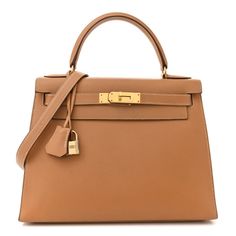 This is an authentic HERMES Courchevel Kelly Sellier 28 in Sable. This Hermes classic handbag is beautifully crafted in stamped Courchevel calfskin leather in brown. A single rolled leather top handle is secured with polished gold plated hardware and an optional leather shoulder strap is included. The traditional gold Kelly turn lock secures the small flap with a padlock. A hanging leather key clochette accessorizes this handbag. The interior features two flat pockets, as well as a zippered pock Kelly Sellier, Classic Handbags, Leather Key, Leather Top, Top Handle, Calf Skin, Shoulder Strap, Key, Handbags