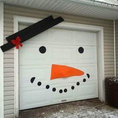 a garage door decorated with a snowman's head and nose painted on it