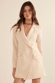 Solid, blazer-style romper. Notch lapel collar. One-button, double-breasted closure. Long sleeves. Padded shoulder. Side pockets. Skort bottom with shorts back. Full lining. Thigh length. Fitted silhouette. 100% Polyester. Chic Notched Blazer Dress For Semi-formal Occasions, Chic Single Button Double-breasted Blazer Dress, Chic Double-breasted Single Button Blazer Dress, Blazer Dress With Notch Lapel For Night Out, Notch Lapel Blazer Dress For Night Out, Night Out Blazer Dress With Notch Lapel, Night Out Single Breasted Blazer Dress With Notch Lapel, Chic Blazer Dress With Double Button And Lapel Collar, Chic Double-breasted Blazer Dress For Date Night