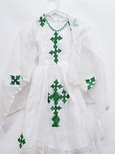 ETHIOPIAN TRADITINAL DRESS FOR KIDS ERITREAN TRADIONAL DRESS CHIC HABESHAWIT COTTO, ZURIA  Ethiopian & Eritrean Traditional clothing Green Embroidered Dress For Dress-up, Green Embroidered Dress For Dress-up Occasions, Festive White Tunic Dress, White Short Sleeve Festive Dress, Fitted Green Dress For Baptism, White Bohemian Short Sleeve Sets, Festive White Beach Dress, Bohemian Dresses For Baptism In Spring, Bohemian Dress For Spring Baptism