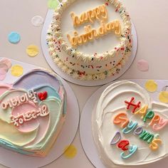 three decorated birthday cakes with happy birthday written on the frosting and decorations around them