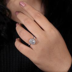 a woman's hand with a diamond ring on it