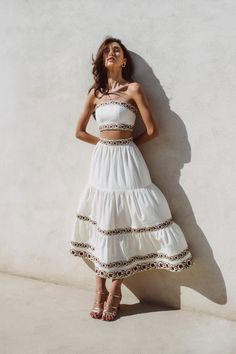 Discover our latest silhouette - a maxi tiered ruffle skirt, featuring our iconic carnation embroidery. Featuring a laced bustier closure on the back with delicate handmade floral details on the tassels, this embroidered ruffle skirt set can be worn with flats on your next a euro-chic escape or dressed up in heels for a cocktail look all summer long. Wear Me: Complete your look with the matching Carnation Crop Top or its the Ivory Malika Bustier Composition & Care: 100% LinenGold PipingDry Clean Matching Maxi Skirt And Top Set, Tiered Skirt Dress, Carnation Embroidery, Tiered Skirt Outfit, Euro Chic, Disco Decorations, Desert Chic, Statement Skirt, Ibiza Outfits