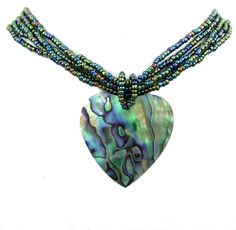 PRICES MAY VARY. This Abalone necklace feature a pendant of iridescent Paua Abalone Shells artfully carved in a beautiful heart shape. The iridescence of the Abalone shell is remarkable. Depending on the angle of the light source they will radiate colors from greens and pinks to purples and blue adding a whole new dimension. It is matched color of color with a gathering of iridescent seed beads to create this beautiful necklace. Shell Type: Paua Abalone Shell Pendant Length: 1.8 x 1.6 inches (45 Abalone Shell Necklace, Abalone Necklace, Necklace Shell, Carved Heart, Nature Necklace, Seashell Necklace, Sea Star, Shell Necklace, Shell Pendant