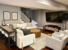 a living room filled with furniture and a flat screen tv mounted on the wall over a fireplace