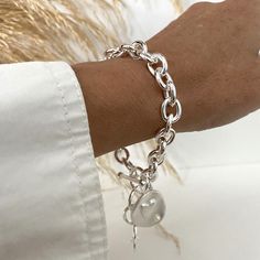 Beautiful chunky bright silver 9.5x11mm cable chain bracelet decorated with MATTE silver heart pattern big charm and toggle clasp, a very nice gift ! You'll be charm by the elegant and stylish look of this bracelet that is perfect as well with chic or casual outfits.  * The chain is in quality silver color plated stainless steel. * The 20x23mm charm is in 925 MATTE silver plated brass decorated with tiny acrylic pearl. On pictures 6.5 inches wrist showing the bracelet attached at 8.25 inches.  Add approximately 1.75 - 2 inches to your wrist size. Care recommandations;  I recommand to keep the bracelet in the box when not worn, avoid water and, if possible, wipe it with soft dry clothe after warring to remove chemical residues of cream and perfume  You will receive this beautiful bracelet i Toggle Bracelet, Heart Pattern, Bracelet For Women, Charm Gift, Stylish Jewelry, Toggle Clasp, Heart Patterns, Silver Heart, Cable Chain