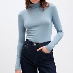 Gap Lightweight Turtleneck T-Shirt In Ice Blue. Size Xs. Washed Once, Never Worn. Perfect Condition. Materials: 56% Cotton, 37% Modal, 7% Spandex/Elastane This Turtleneck Is A Perfect Basic. Very Lightweight And Great For Layering. Only Selling It Because The Color Doesn't Look Good On Me! P.S. Sorry It's A Bit Wrinkly -- It Was Scrunched Up In My Closet For A Long Time! Gap Relaxed Fit Tops For Fall, Trendy Blue T-shirt For Fall, Blue Turtleneck Top For Fall, Gap Fitted Tops For Fall, Gap Tops For Spring, Light Blue Stretch Basic Top, Basic Blue Tops For Fall, Gap Fitted Long Sleeve Tops, Trendy Long Sleeve Tops From Gap