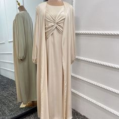 This Lux Two Piece Set is made from high-quality satin, and includes a long sleeve inner dress with chest design and a long sleeve open abaya in a matching color. Available in 6 beautiful colors. Elegant Solid Color Abaya For Fall, Elegant Solid Abaya For Fall, Elegant Solid Color Dresses For Eid, Evening Solid Color Maxi Length Abaya, Evening Solid Maxi Length Abaya, Elegant Solid Color Abaya For Eid, Evening Maxi Length Solid Abaya, Elegant Long Sleeve Maxi Dress For Eid, Elegant Satin Maxi Abaya