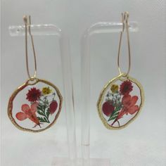 pair of earrings with flowers painted on them