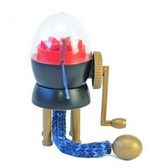 a snow globe on top of a ball with a blue rope around it and a gold hook