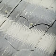 a close up view of a shirt with buttons on it