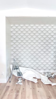 an unfinished room with white walls and wood floors