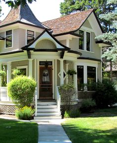 a house with white trim and brown roof