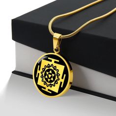 "Unique Personalized Baglamukhi Yantra Necklace!  ➜ Our patent-pending jewelry is made of high quality surgical steel with an 18k gold finish option. ➜ Our jewelry is personalized in the U.S.A by awesome working moms just like yours! We hire and train working mothers and pay a living wage. We are proud to support strong communities and keep jobs in America! This Bagalamukhi Yantra Pendant Is the Perfect Keepsake! Whether for Yourself or a Loved One. ➜ If the custom engraving option is available, engrave onto the back of the pendant your loved one's name, your wedding date, an anniversary, or anything else you want to remember and keep you close to her heart. Each personalized piece offers exceptional craftsmanship that is fit to be an instant classic in your family. We Offer a 100% Happine Round Spiritual Temple Necklace As Gift, Spiritual Round Temple Necklace As Gift, Navratri Brass Jewelry Gift, Navratri Gift Temple Necklace, Round Temple Necklace For Navratri Gift, Symbolic Jewelry For Navratri Rituals, Black Necklaces For Navratri Gift, Black Necklaces For Navratri As A Gift, Black Jewelry Gift For Navratri