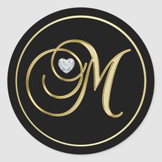 a black and gold monogrammed sticker with the letter m in it's center