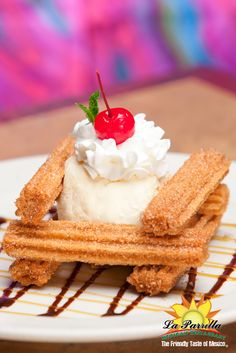 a waffle topped with whipped cream and a cherry garnish sits on a plate