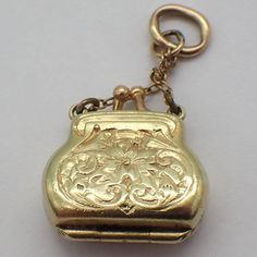 "Vintage 14k (.585) yellow gold locket charm or pendant in form of a lady's purse, decorated with engraved patterns. This charming piece is 1 1/8\" long, 1/2\" wide, weighing 2.6 grams. EA4944" Formal Yellow Gold Filigree Locket Necklace, Gold Engraved Necklaces For Evening, Gold Engraved Necklace For Evening, Ornate Yellow Gold Hallmarked Locket Necklace, Elegant Gold Locket Necklace With Charms, Gold Rectangular Filigree Jewelry, Antique Gold Locket Necklace With Charms, Antique Locket Jewelry For Evening, Gold Antique Locket Necklace With Charms