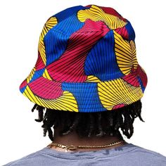 A unisex bucket cap made using authentic Ankara fabric. 58cm. Ankara, also known as African wax print or Dutch wax print, is a fabric characterized by vibrant patterns and colors. The fabric is made through a wax-resist dyeing technique called batik which creates distinct and colorful patterns. Ankara fabric is used to make a wide range of clothing and accessories, including dresses, skirts, shirts, and hats. Each pattern carries cultural meanings and stories making pieces made from this fabric not just fashion items but also carriers of African heritage and identity. Dutch Wax Print, Raffia Sun Hat, Resist Dyeing, Raffia Hat, African Heritage, Bucket Cap, Wax Resist, Vibrant Patterns, Colorful Patterns