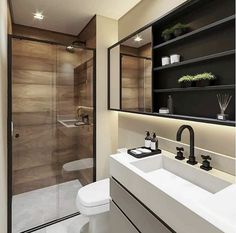 a bathroom with a toilet, sink and shower stall in the corner is lit by recessed lights