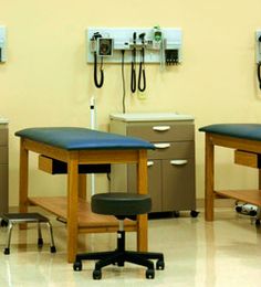 three hospital beds in a room with medical equipment