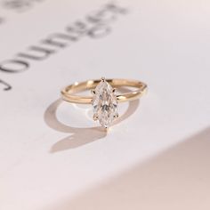 a diamond ring sitting on top of a piece of paper