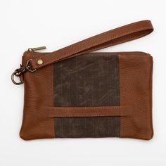 Stylish and durable, this Eastport Clutch is made to accompany you on all of your travels. Perfect for those on the go! Attach the Eastport Clutch to the inside of the Saco River tote Bag or the Fore Street Tote Bag (sold separately) to make a stylish set. Due to the nature of the leather, variations in color may occur. Made in a solar-powered workshop in Maine. Includes detachable leather wrist strap with a bronze lobster clasp built-in leather hand clutch strap zip-top closure Materials waxed Hand Clutch, Navy And Brown, Waxed Canvas, Solar Powered, Leather Purse, Zip Top, Wrist Strap, Full Grain Leather, Fabric Patterns