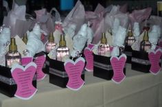 several small bottles with pink and white hearts on them are sitting on a table in front of each other