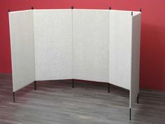 a room divider with three black poles on each side and two white panels in the middle