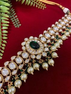 Premium quality next to real moissanite kundan choker necklace . Designer piece worn by Bollywood actress Alia bhatt. Widest part of the choke is 1.75 inch. earring is about 3 inch long . Screw back. Pearl drops and AD details. Center is a emerald green American diamond. Necklace Band is about one inch wide. Mathew Bollywood Style Chandbalis With Tilla For Designer Wear, Kundan Chandbalis With Tilla For Designer Wear, Designer Kundan Chandbalis With Tilla Detail, Kundan Jewelry With Gota Work For Designer Wear, Bollywood Style Designer Jewelry With Gota Work, Designer Kundan Jewelry With Gota Work, Temple Jewelry With Gota Work, Designer Kundan Chandbali Necklace, Heavy Chandbali Kundan Necklace For Designer Wear