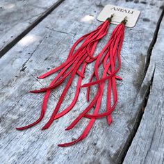 -These boho tassel earrings are made from soft red deerskin leather.  Part Cowgirl, part Biker, part Rock & Roll, the tassel earrings give a big kick to any outfit.-Dramatic but lightweight enough to wear every day. -9" total length.-Earwires are antique-brass.  Goldfill earwires are available by request. -Deerskin leather is sustainably sourced in the USA.-Ok to get wet.-Available in 14 colors.-Designed and handmade in South Pasadena, CA.Check out more of our lovely earrings here:https://ww Adjustable Red Leather Earrings, Red Leather Earrings For Gifts, Adjustable Red Bohemian Tassel Earrings, Red Leather Earrings, Red Statement Earrings, Leather Tassel Earrings, Chevron Jewelry, Jewelry Making Business, Leather Jewels