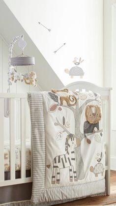 a baby crib bedding set with animals and trees