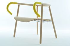 a chair with a yellow handle on the back and arms, sitting in front of a white background