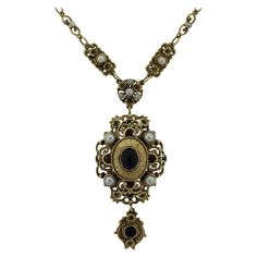 A large vintage gold necklace made in the antique-style with Victorian features. The necklace showcases two amethyst cabochons along with multiple pearls set along the necklace. There is filigree goldwork as well as millgrain which are classic styles of antique jewelry. Made in 14k yellow gold. Necklace Chain Length: 18.5 inches Drop Length: 3 inches Antique Pearl Necklace For Formal Occasions, Ornate Jeweled Necklaces For Formal Occasions, Victorian Antique Gold Necklace For Formal Occasions, Victorian Pearl Necklace For Formal Occasions, Victorian Style Formal Pearl Necklace, Victorian Jeweled Necklaces For Formal Occasions, Elegant Antique Gold Jeweled Jewelry, Elegant Antique Gold Cabochon Necklace, Ornate Gold Necklace With Cabochon