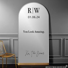 a chair sitting in front of a sign that says you look amazing with the words rw on it